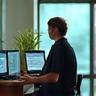 Person meditating discreetly at an office desk